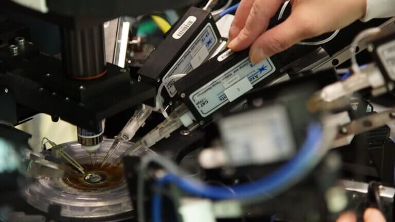 Photo of a hand on an electrophysiology rig