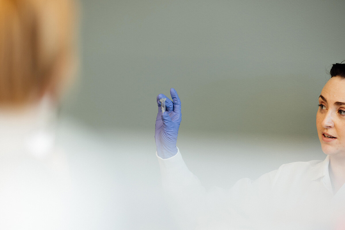 Scientist Emily holding up a vial