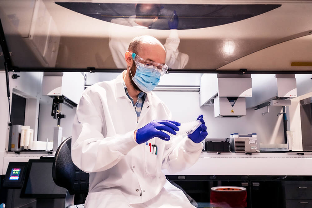 Scientist with mask working in lab