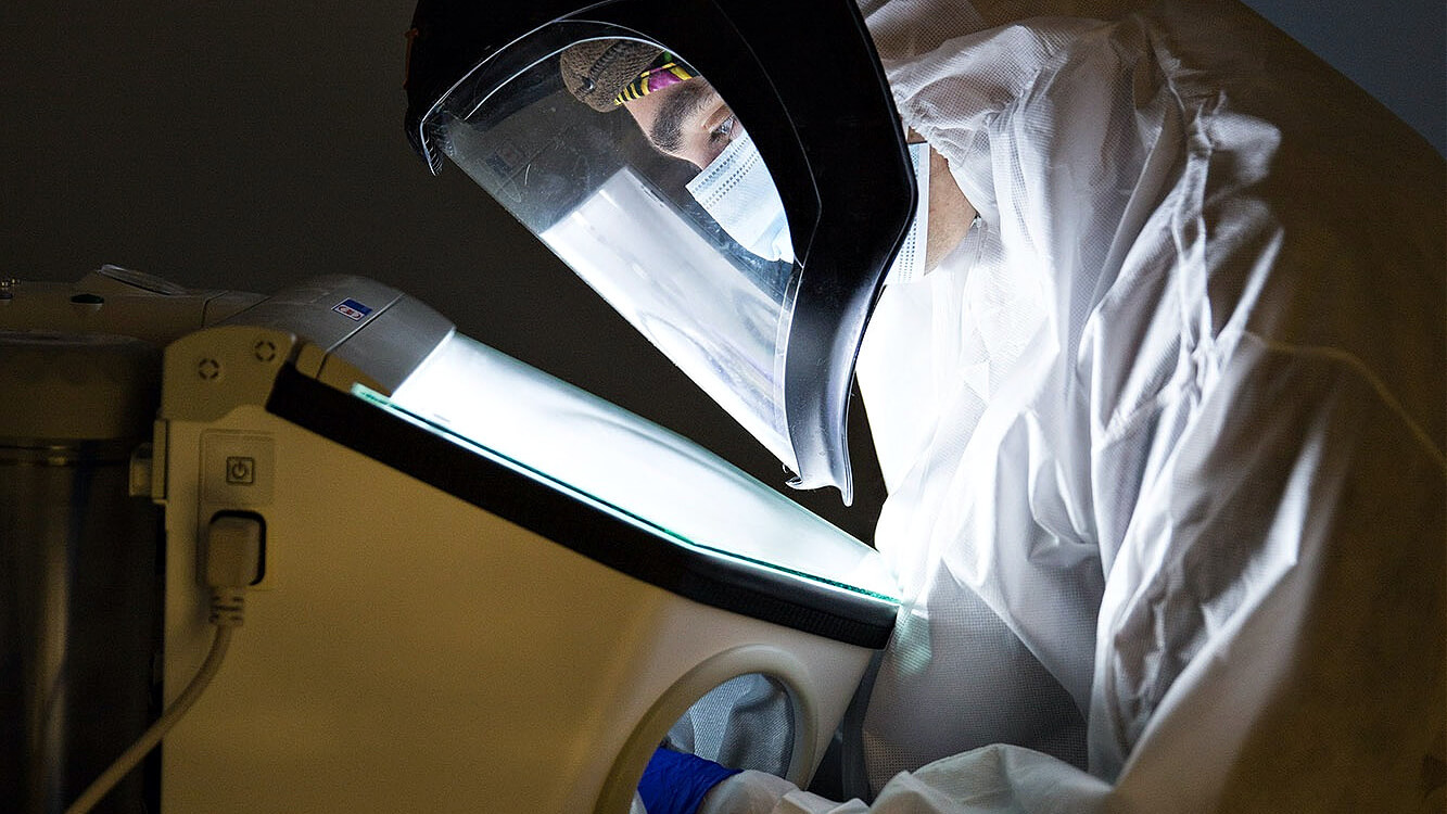 http://Researcher%20in%20protective%20suit